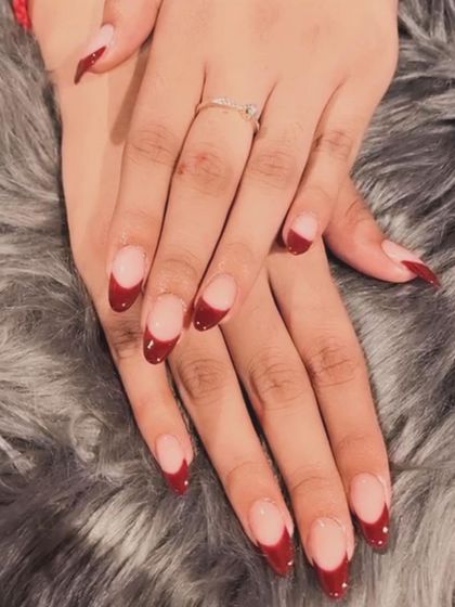 A deep red French tip provides a dramatic and sophisticated look. This is a great choice for festive occasions or a bold everyday style.