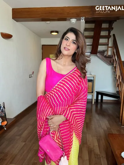 We had the pleasure of styling the brilliant Tahira Kashyap. For this look, we focused on a fresh, vibrant makeup style with a bold pink lip to complement her bright outfit, paired with soft, bouncy hair for an effortlessly chic appearance.