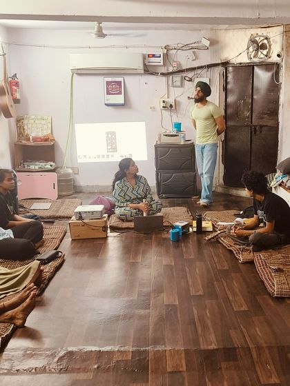 A facilitator uses a projector to guide a discussion, showing how we incorporate different teaching tools to make the sessions interactive and informative.