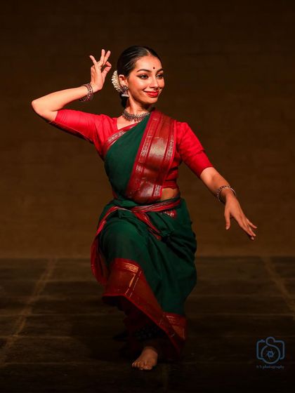 A graceful pose from a solo recital. The focus here is on the subtle storytelling through hand gestures and facial expression, which is the heart of abhinaya.
