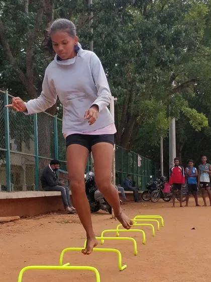 Fitness is key in Kho-Kho. Here, one of our female players works on her speed and footwork with agility hurdle drills. We welcome and train both boys and girls to reach their peak performance.