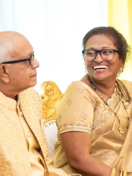 A sweet, candid moment between the couple during their golden anniversary celebration. Their shared laughter is a beautiful thing to witness.