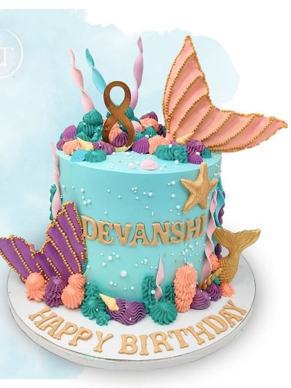 A beautiful mermaid-themed cake for Devanshi's 8th birthday, decorated with shimmering tails and colorful coral in pastel shades.