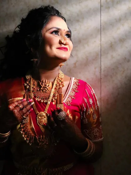 A beautiful shot of the bride looking up, the light catching her glowing skin and the intricate details of her jewelry.