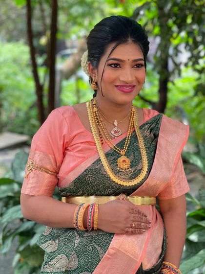 A smiling portrait of Roja. The makeup is designed to enhance her features and give her a beautiful, celebratory glow.