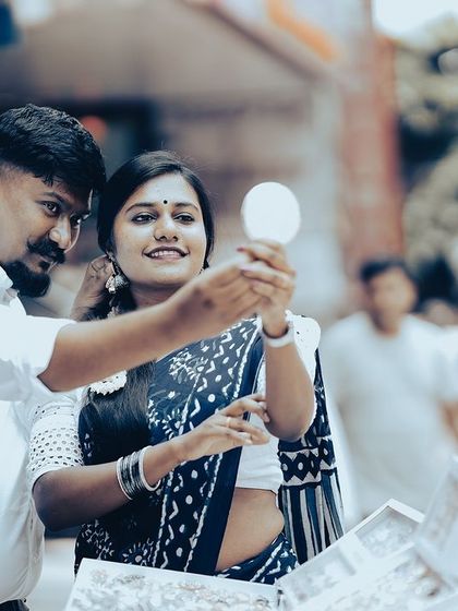A playful moment of shopping for jewelry on the street, capturing the couple's fun interaction in a real-world setting.