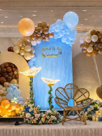 A lovely naming ceremony setup combining a teddy bear theme with other playful elements. We included custom 'BABY' blocks, a blue corrugated backdrop, and floral details to create a unique and personalized stage.