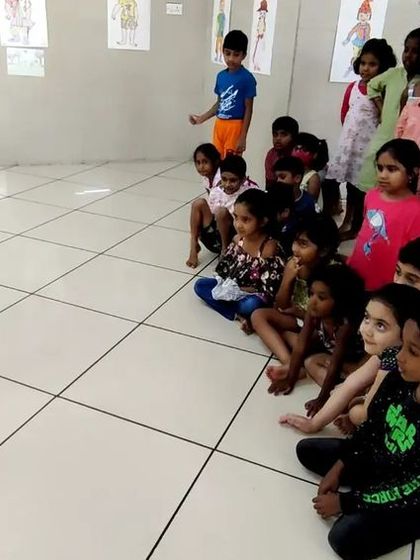 A group of children eagerly watching a performance during a workshop. We always start with a show to inspire them before they begin making their own puppets.