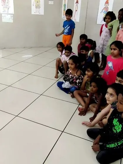 Children watching intently as a marionette puppet is demonstrated in one of our puppetry classes.