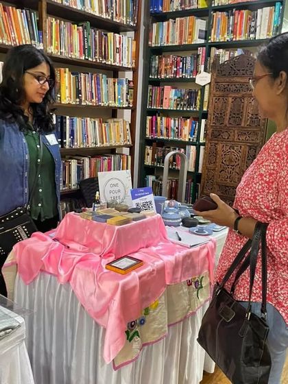 Chatting with a customer at the Philo Fair. The library setting provided a wonderfully cozy and intimate atmosphere for sharing my work.