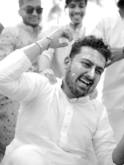 Pure, unadulterated joy. This black and white shot of the groom during his haldi ceremony is bursting with energy and laughter.