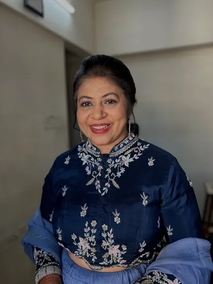 A smiling portrait showing her final look. She looks confident and ready for the celebration.