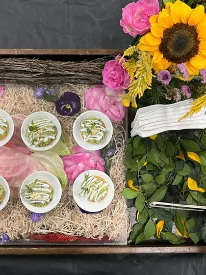 Our luxury gifting hampers are designed to make a lasting impression. This beautifully arranged tray features a selection of our gourmet appetizers, fresh flowers, and elegant cutlery, perfect for corporate gifting or as a wedding favour.