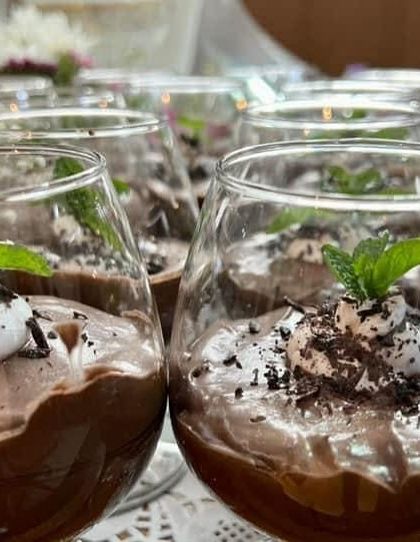 A close-up of the chocolate mousse, showing the creamy texture and delicate garnish. It's a dessert that tastes as good as it looks.