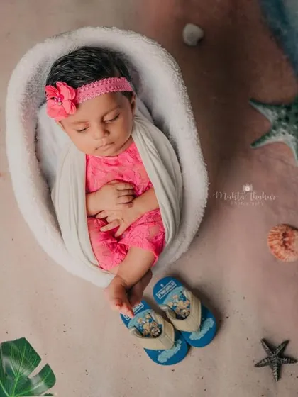 A sleepy moment during the studio beach session. The baby is swaddled comfortably, dreaming of the ocean.