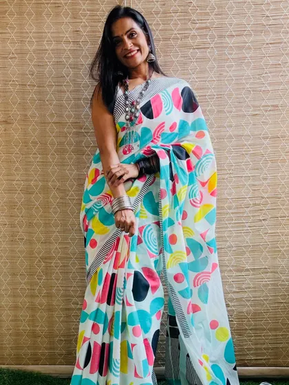 This white cotton Mulmul saree with a colorful abstract print is modern and artistic. It's a fun saree that shows off your creative side.
