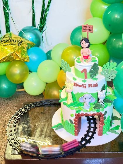The Jungle Book cake at the party, perfectly matching the green and wild decorations.