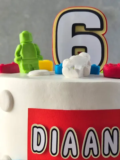 A close-up of the handmade Lego toppers, showing the detail that goes into each custom cake.