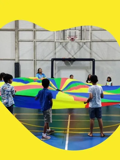 It’s not all about traditional sports. We use fun equipment like this giant parachute for team-building games that teach cooperation and communication. These activities are always a huge hit and result in lots of laughter.