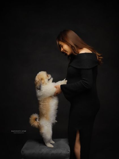 A heartwarming moment between a mother-to-be and her small dog. Capturing this bond before the baby arrives is so special.