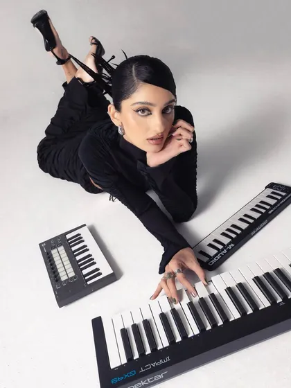 Here's me in my element, surrounded by the tools of the trade. I use a mix of keyboards and synths like the Nektar Impact and Novation Launchkey to find the perfect melody and build tracks from the ground up.