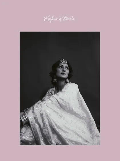 A soft and elegant portrait. The model is styled in a white Chikankari ensemble, offering a lighter, more ethereal bridal or pre-wedding look. The black and white treatment adds a touch of classic romance.