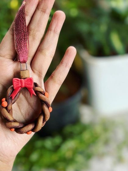 A closer look at the braided ceramic wreath ornament, a piece from a past Christmas collection.