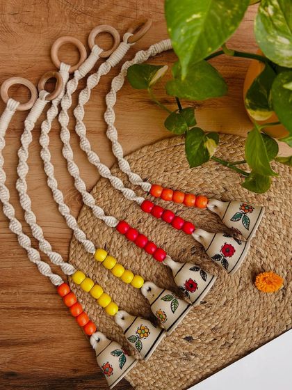 A beautiful flat lay of our beaded macrame bells, showcasing the different color combinations available. These little handmade creations are perfect for adding a pop of color and a touch of charm to your home.