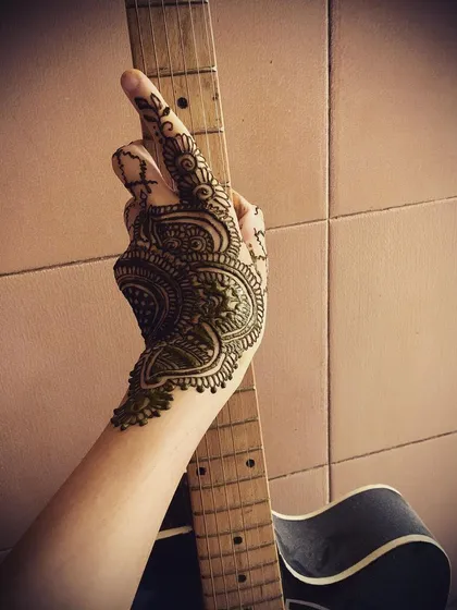 A modern take on a partial-hand design, featuring bold paisley and mandala elements. This style is great for casual parties or for anyone who loves music and art.