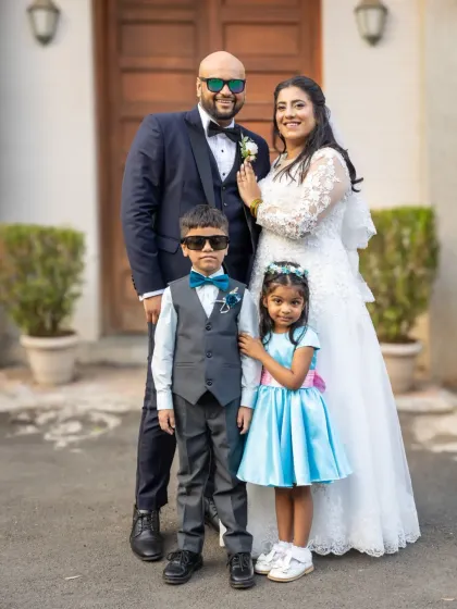 A classic family portrait with the bride, groom, page boy, and flower girl. A beautiful memory of the complete wedding party.