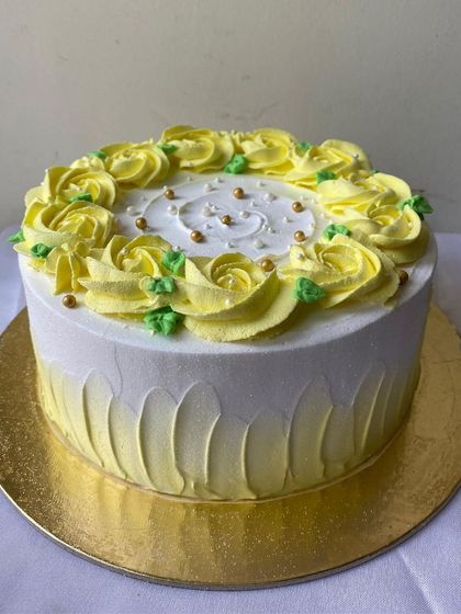 A classic floral cake with yellow buttercream roses. This timeless design is perfect for any celebration, including Mother's Day.