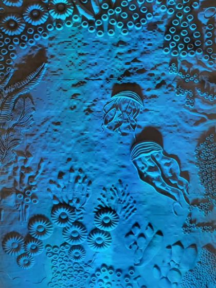 The final installation, titled 'Silent Architects of the Sea', under dramatic blue light. We used lighting to simulate an underwater environment and to highlight the beautiful, intricate textures of the coral wall we created. The effect was designed to be both beautiful and haunting.