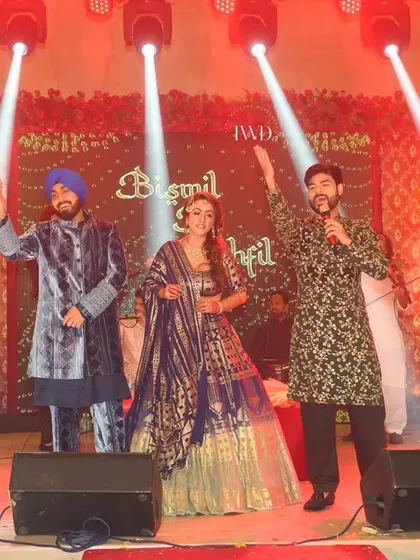 The couple joins the artist Bismil on stage during their Sufi night. This interactive moment shows the joy and connection that live music can bring to a wedding celebration, making it personal and memorable.