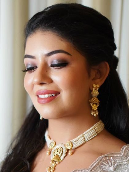 A close-up on the eye makeup for this elegant look. The silver and charcoal glitter creates a sophisticated smokey effect that is perfect for an evening celebration.