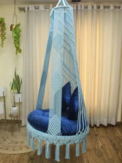 This single seater swing in a light sky blue with a navy cushion is a calming and beautiful addition to any room. It's perfect for a girl's room or a serene corner.