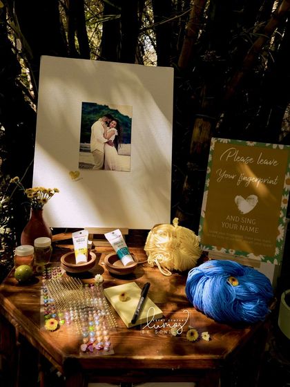 Another view of the fingerprint counter, with colorful paints and a personalized sign, adding a fun activity to the celebration.