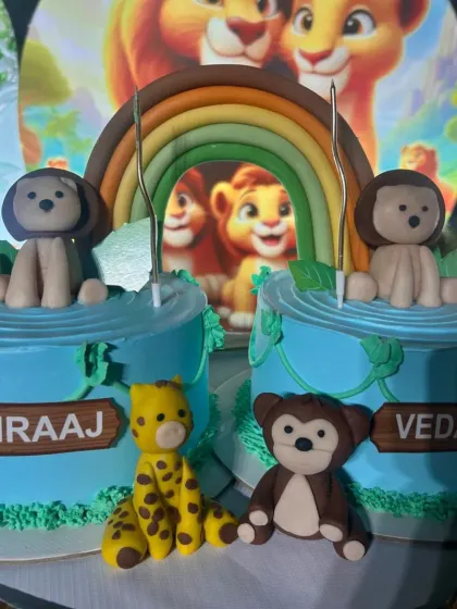 The details on these matching Lion King cakes, from the fondant rainbow to the individual animal figures, make for a memorable celebration.