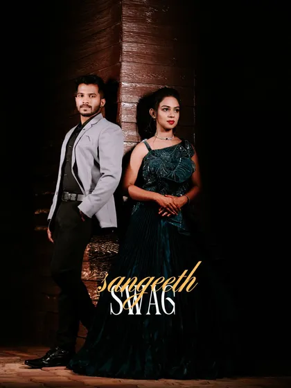 "Sangeeth Swag." A cool, stylish portrait of the couple ready for their Sangeet night. The dark, moody lighting highlights their modern and fashionable outfits.