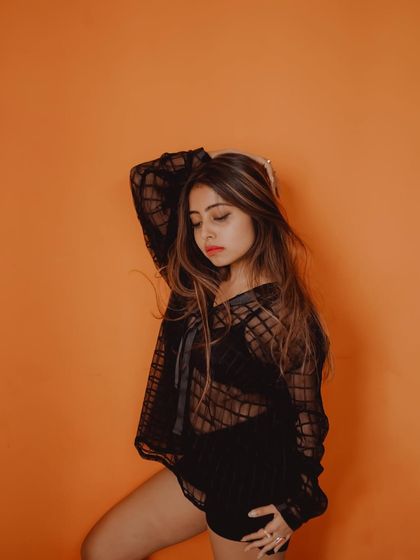 This image has a thoughtful, introspective mood, enhanced by the simple styling and the bold color of the background.