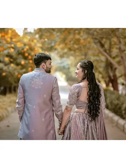 A simple, heartfelt shot from behind as the couple holds hands. This perspective in couple photography emphasizes their connection and shared journey forward.