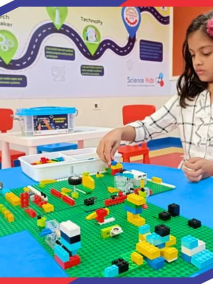 A student carefully assembles a project on a LEGO baseplate. This kind of focused, hands-on activity is central to our teaching method, helping develop fine motor skills, spatial reasoning, and patience.
