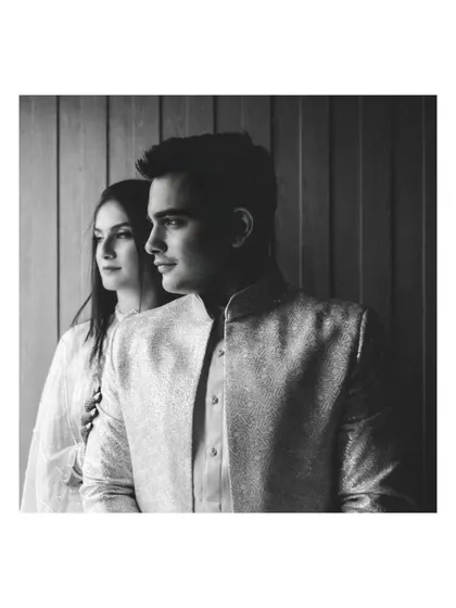A classic black and white portrait using shadows and light to create a dramatic, high-contrast image. This technique adds a sense of sophistication and artistry to engagement photography.
