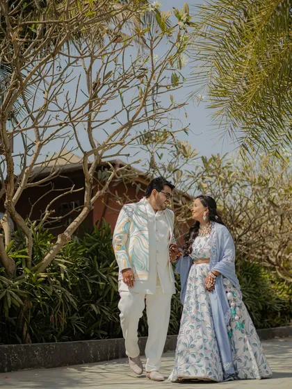 A candid walking shot of the couple in a beautiful outdoor setting. Natural light and surroundings create a relaxed and authentic feel.