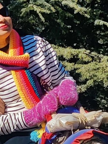 A customer enjoying the outdoors in our rainbow muffler and matching fingerless gloves. The perfect cozy combo.
