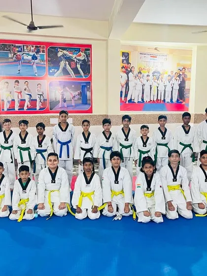 The full strength of Team Oscar. A large group of dedicated students, all kneeling in the traditional martial arts posture of respect and discipline.