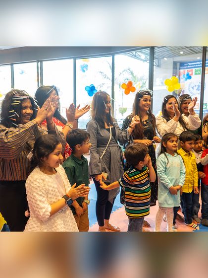 Guests clap and cheer during the cake-cutting ceremony, sharing in the birthday boy's excitement.