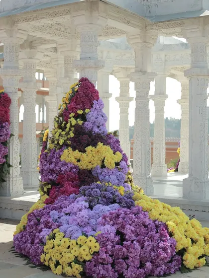 A close-up of the massive floral installation, showing the rich texture and color variation of the chrysanthemums used.