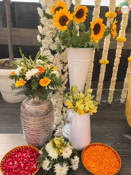 A close-up of the vibrant floral arrangements, including sunflowers and baskets of petals, ready for the Haldi ceremony.