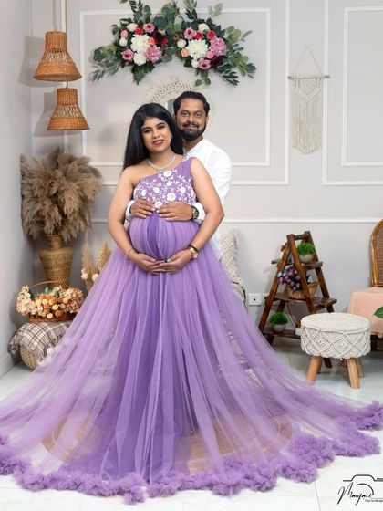 A beautiful portrait of an expecting couple in the boho setup. The lavender gown and his simple white shirt create a soft and romantic color palette.