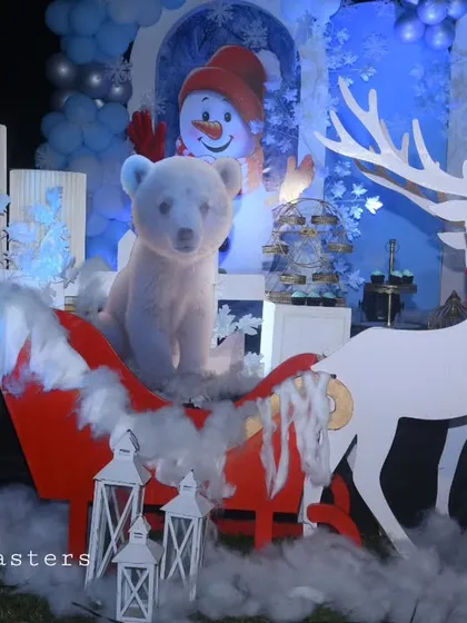 A magical sleigh scene from our winter wonderland party, featuring a polar bear prop, a reindeer cutout, and artificial snow for a truly festive feel.
